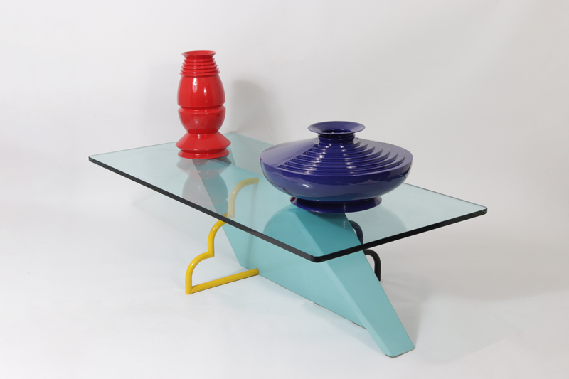 Lot 148, Blue Painted Coffee Table (1980). Pictured atop the table (from left): Lot 201 Sergio Asti for Sapergo Nara and Jaiper Vases; Lot 202 Sergio Asti for Sapergo BKK Vase