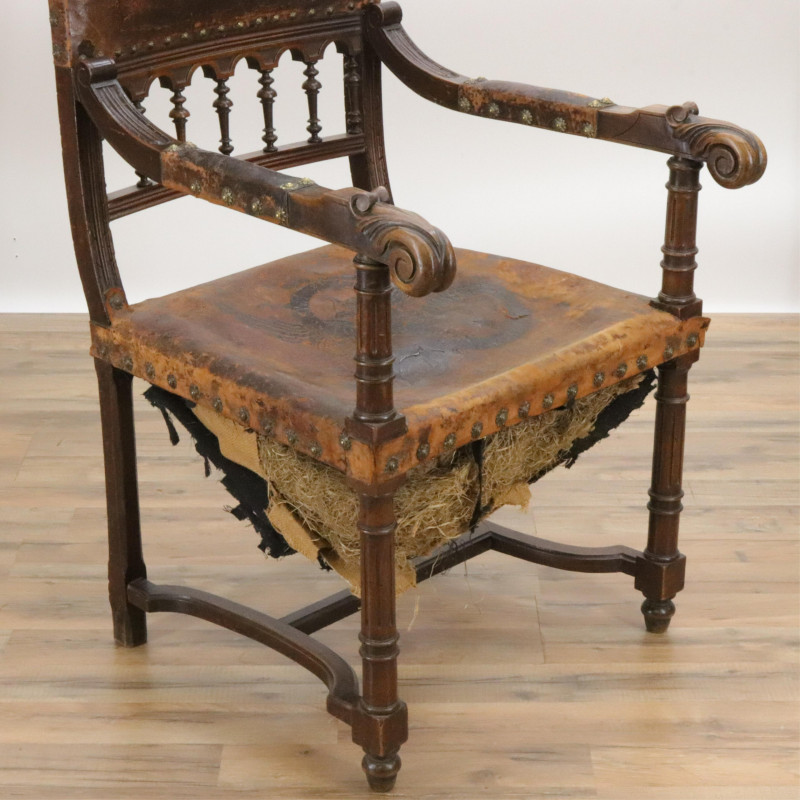 Two Gothic Revival Carved and Leather Armchairs