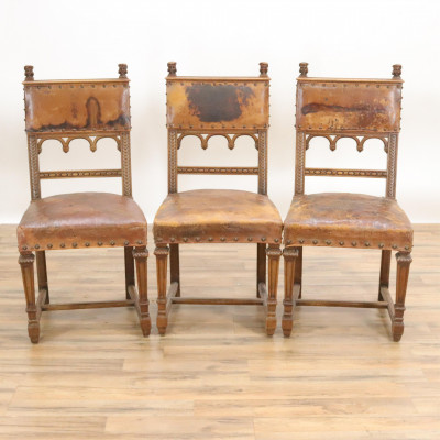 Five Gothic Revival Carved and Leather Side Chairs