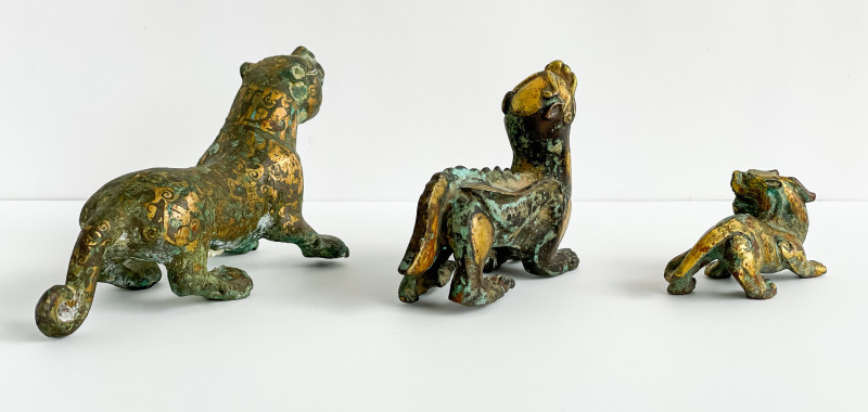 Three Chinese Parcel Gilt Bronze Figures of Lions