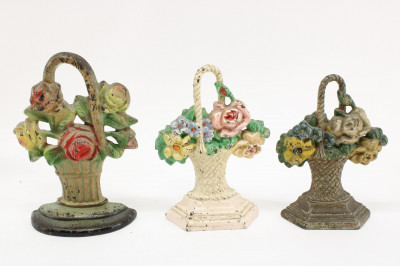 Image 2 of lot 10 Cast Iron Doorstops; floral baskets, windmill