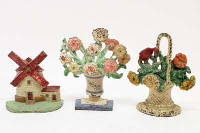 Image 5 of lot 10 Cast Iron Doorstops; floral baskets, windmill
