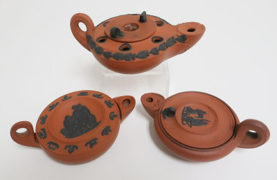 Image 1 of lot 3 Wedgwood Rosso Antico Oil Lamps